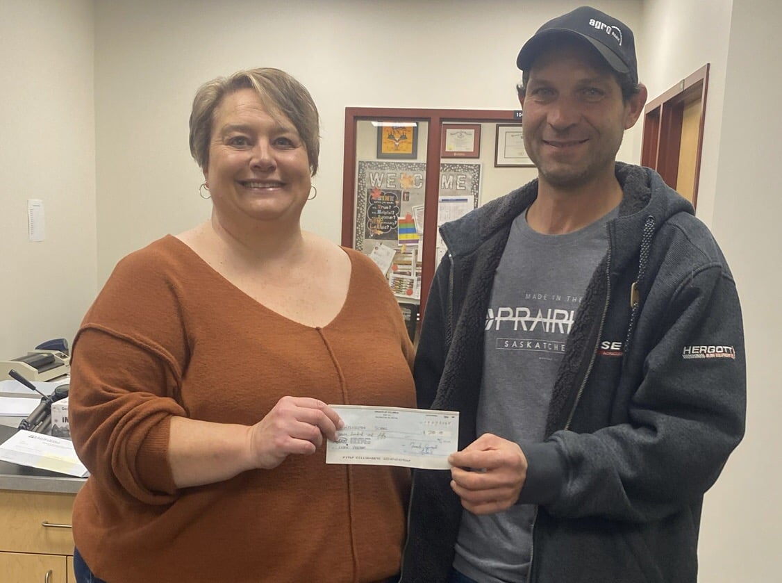 Feeding the Hungry in the Kelvington Area 2 Br. Mike Federko, DKG, presents the cheque to the Principal of Kelvinton School