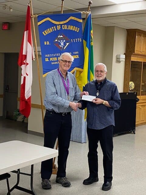 SS Peter & Paul Council 11775 in Saskatoon Presents Their Incentive Cheques 8 Father Ray Lukie, pastor of Saints Peter & Paul Parish, to support family activities at the parish.