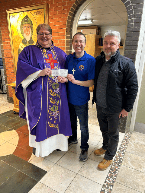 Msgr. Robinson Council #8279 in Saskatoon Presents Their Incentive Cheque 1 Father David Tumback, Grand Knight Travis Vellacott and Sandor Laczco a fellow knight in the council