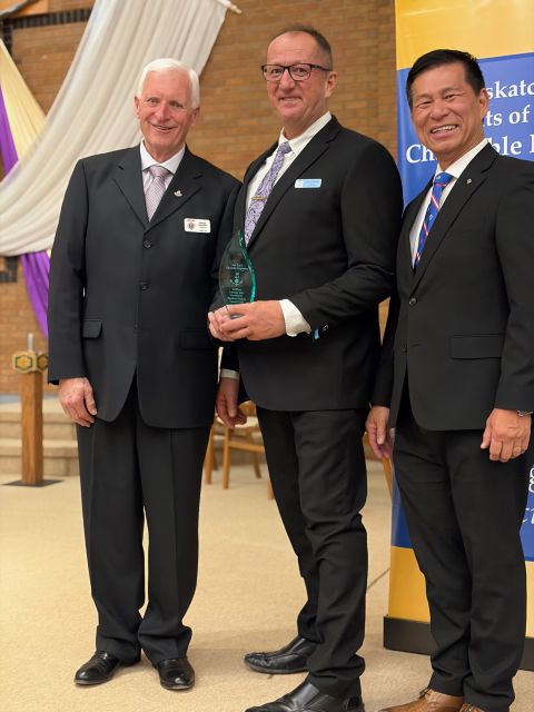 Davidson/Outlook Council 5384 - PSD Larry Packet accepts the award for Grand Knight David Alm, Sask K of C Charitable Foundation President Harvey Grantier, and Supreme Representative Toni Pascua