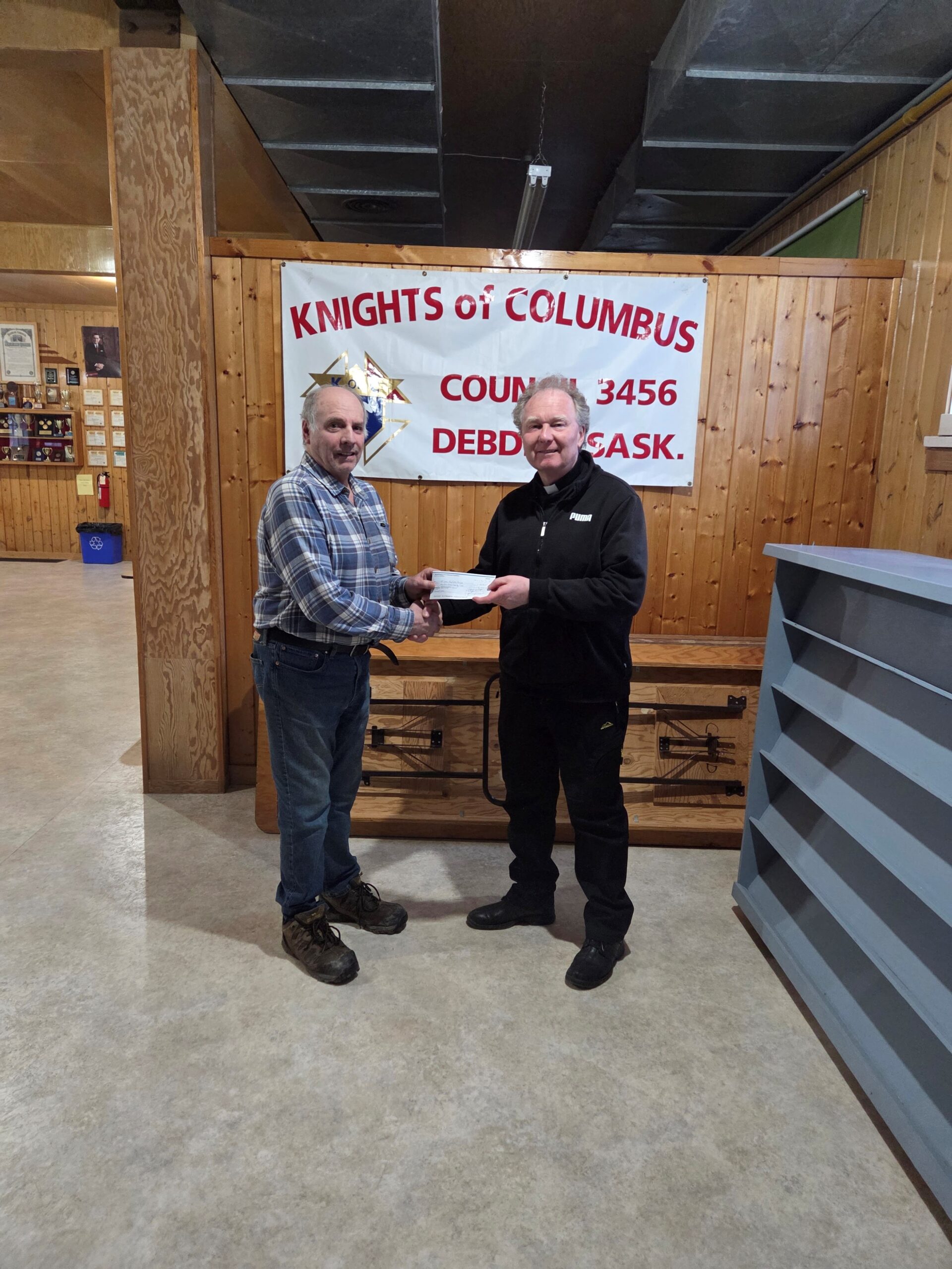 Debden Council #3456 Presents Their Incentive Cheques 2 FS Claude Ruel (left) with Father Mariusz (on behalf of Debden Parish)