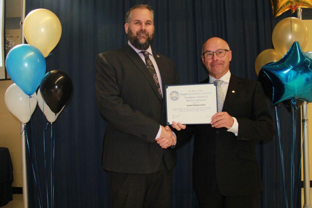 Liam was not in attendance so the photo has the College president Rob Harasymchuk accepting for him